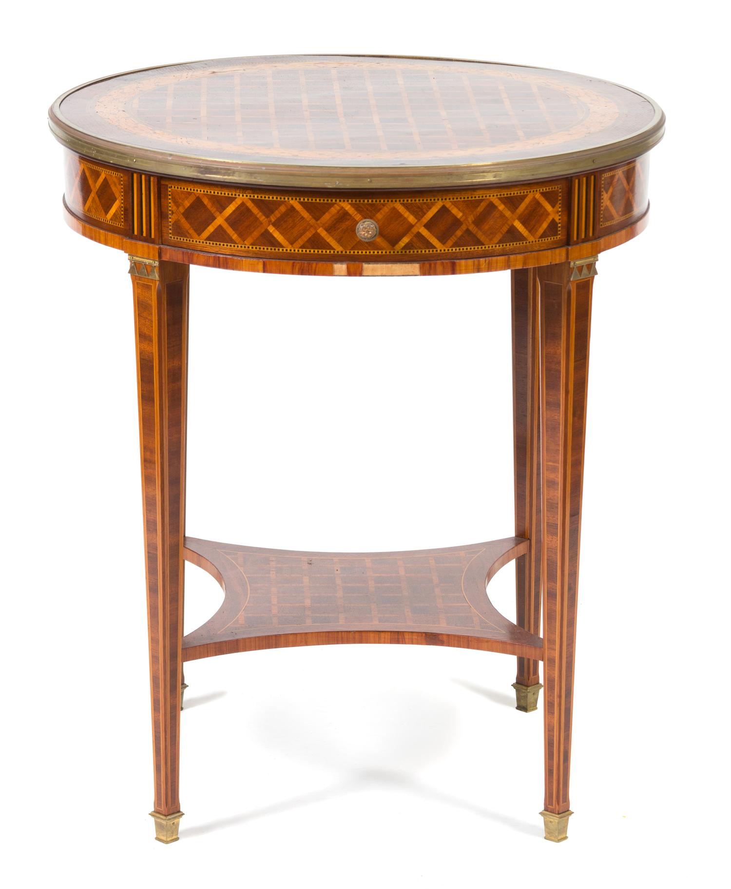 A Louis XVI Style Parquetry Inlaid Gilt Bronze Mounted Gueridon Height 29 1/2 x diameter 25 1/2 inches. — 19TH CENTURY