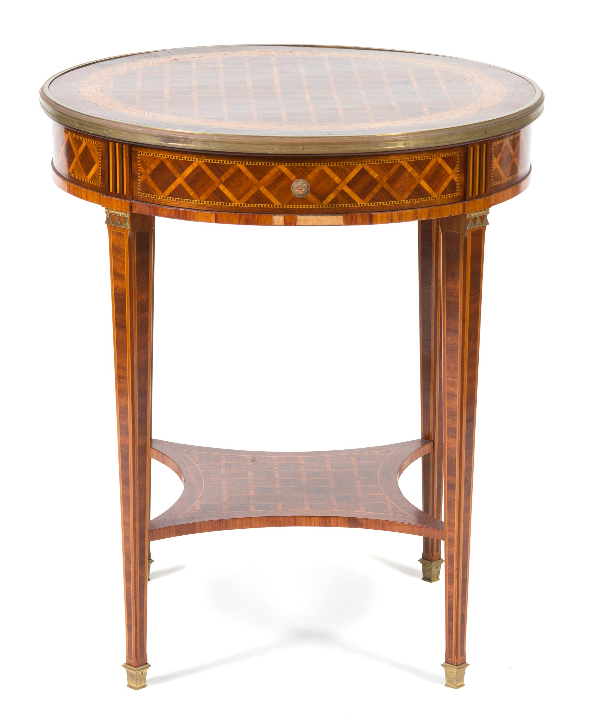 A Louis XVI Style Parquetry Inlaid Gilt Bronze Mounted Gueridon Height 29 1/2 x diameter 25 1/2 inches. — 19TH CENTURY