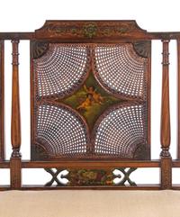 An Edwardian Painted Satinwood Caned Settee