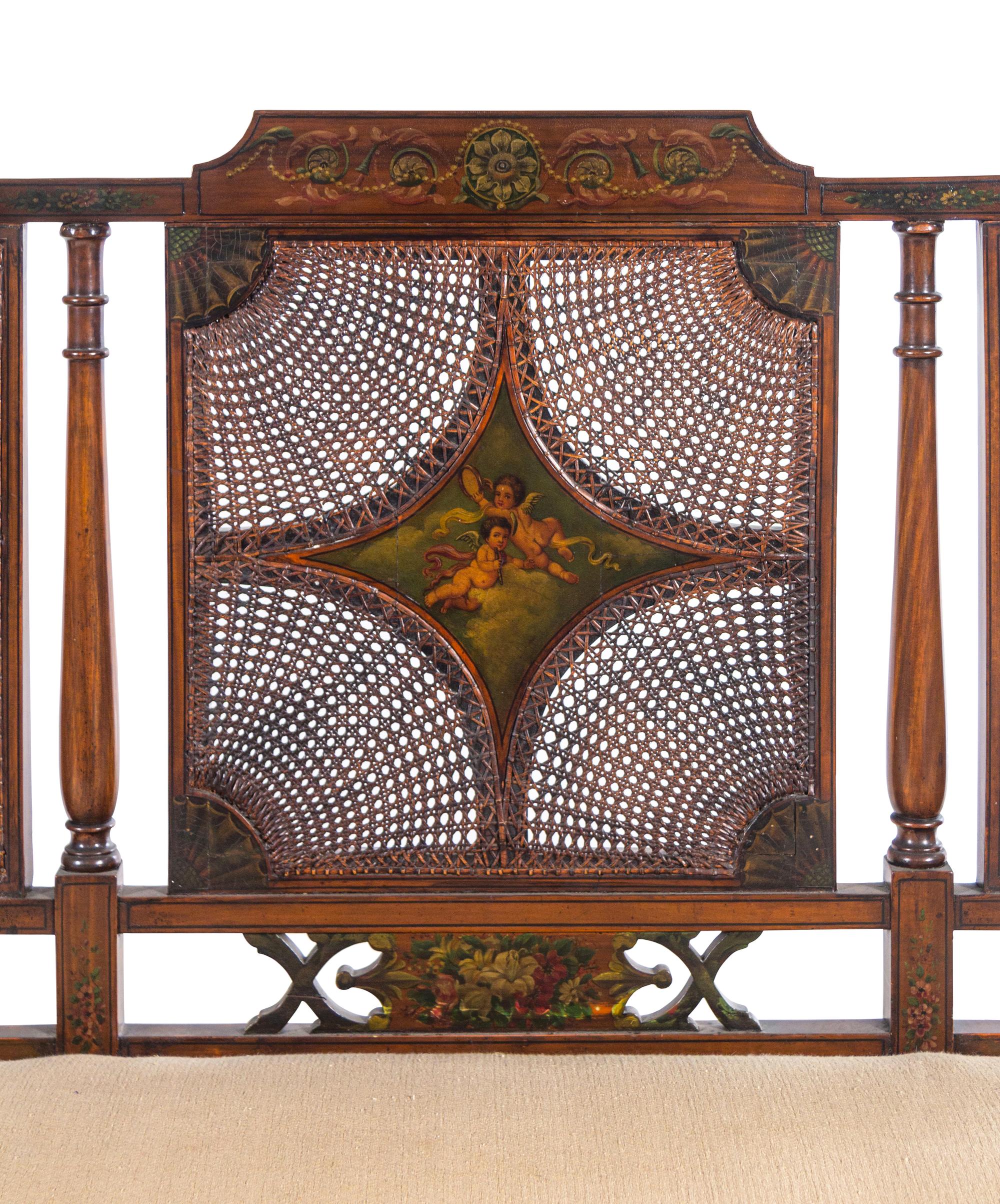 An Edwardian Painted Satinwood Caned Settee