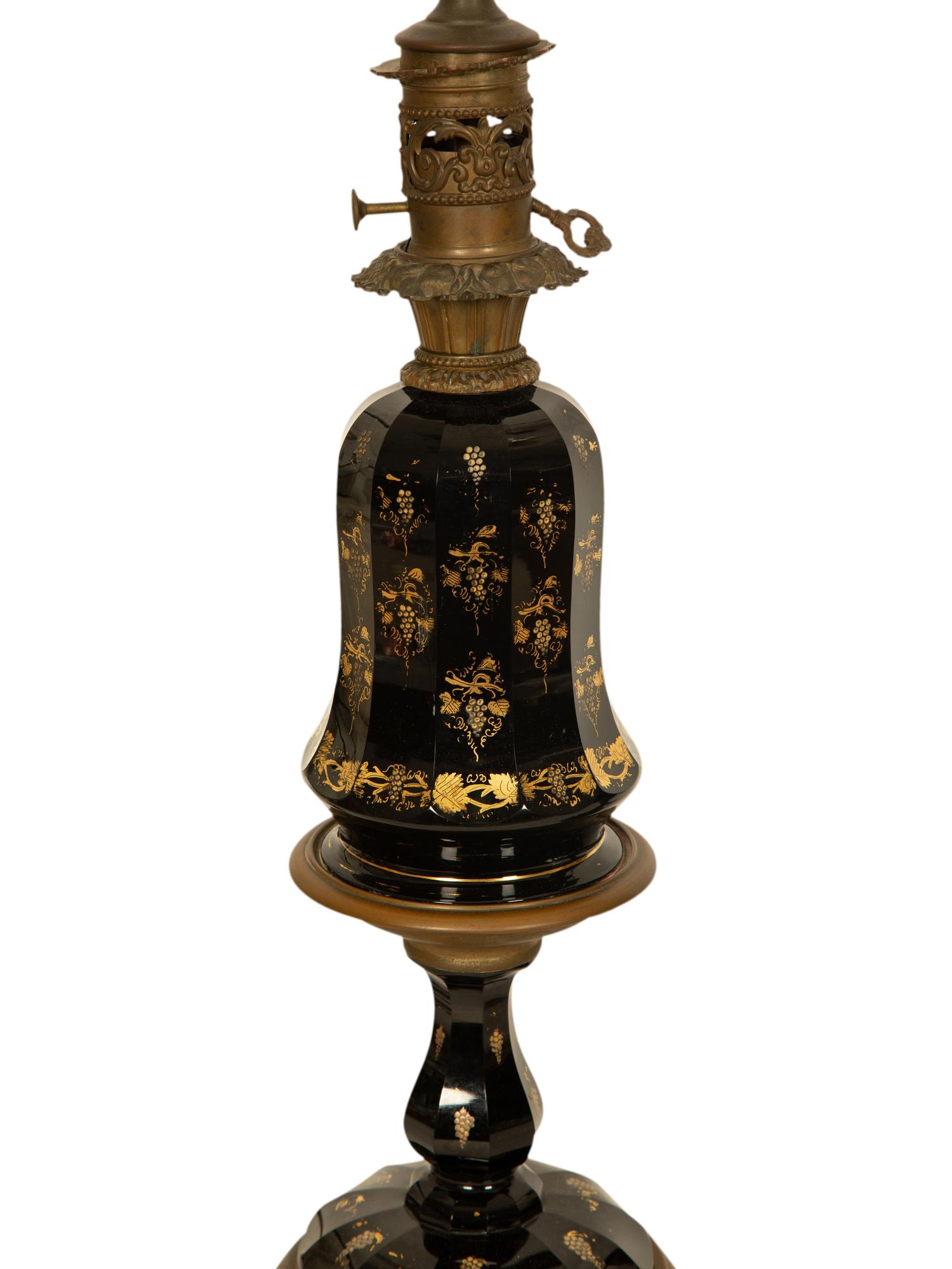 A Pair of Gilt Decorated Black Glass and Gilt Metal Oil Lamps