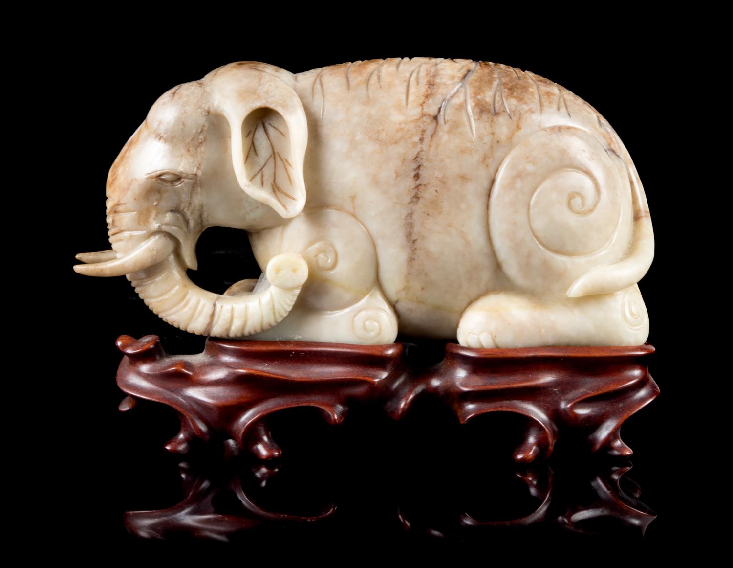 A Mottled Jade Figure of an Elephant Length 7 inches.