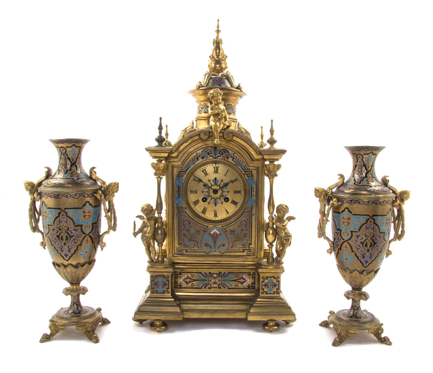 A Continental Gilt Bronze and Champleve Clock Garniture, 19TH/20TH CENTURY, MOVEMENT BY JAPY FRERES, Height of clock 21 inches. — 19TH/20TH CENTURY, MOVEMENT BY JAPY FRERES,