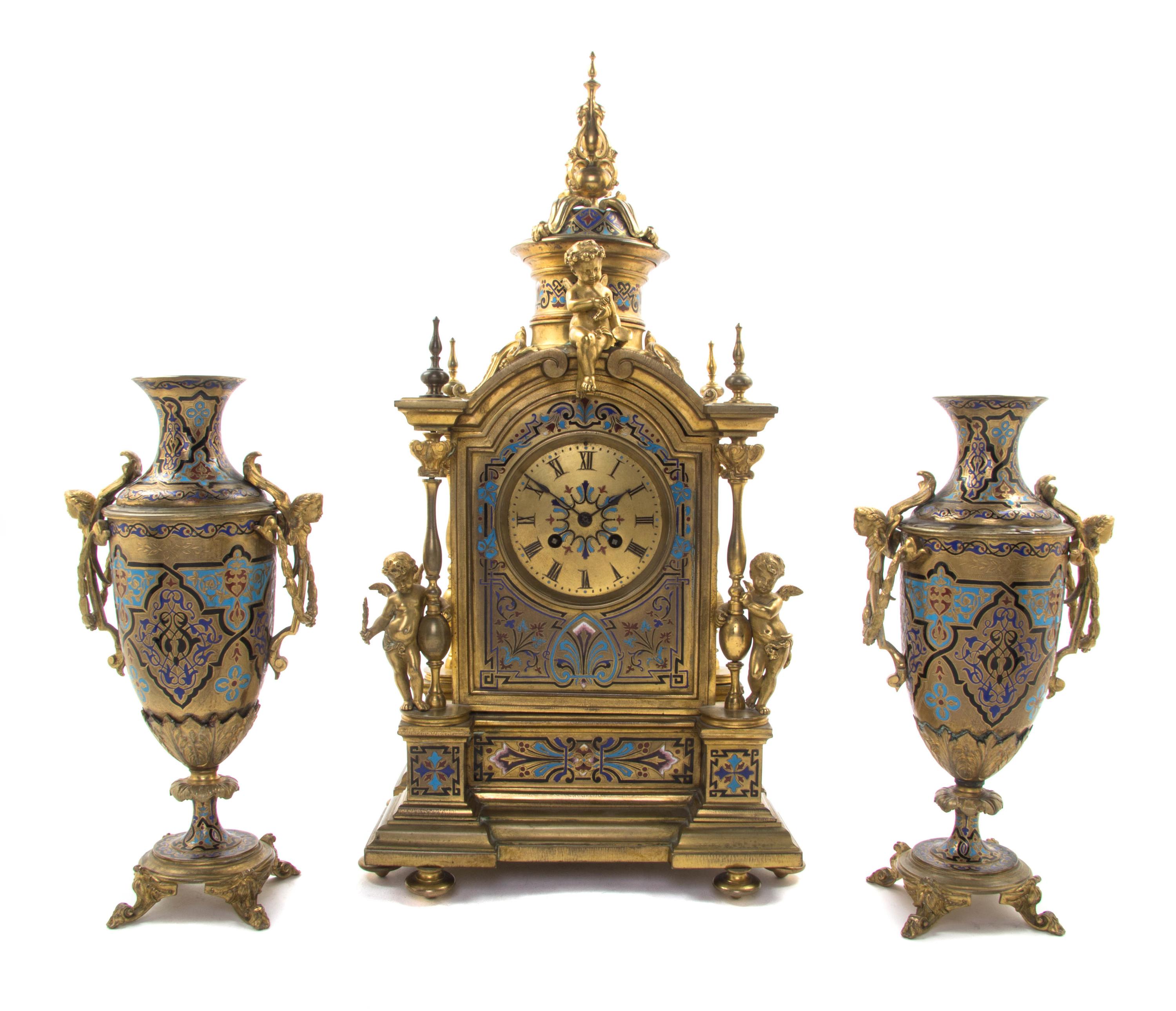 A Continental Gilt Bronze and Champleve Clock Garniture, 19TH/20TH CENTURY, MOVEMENT BY JAPY FRERES, Height of clock 21 inches. — 19TH/20TH CENTURY, MOVEMENT BY JAPY FRERES,