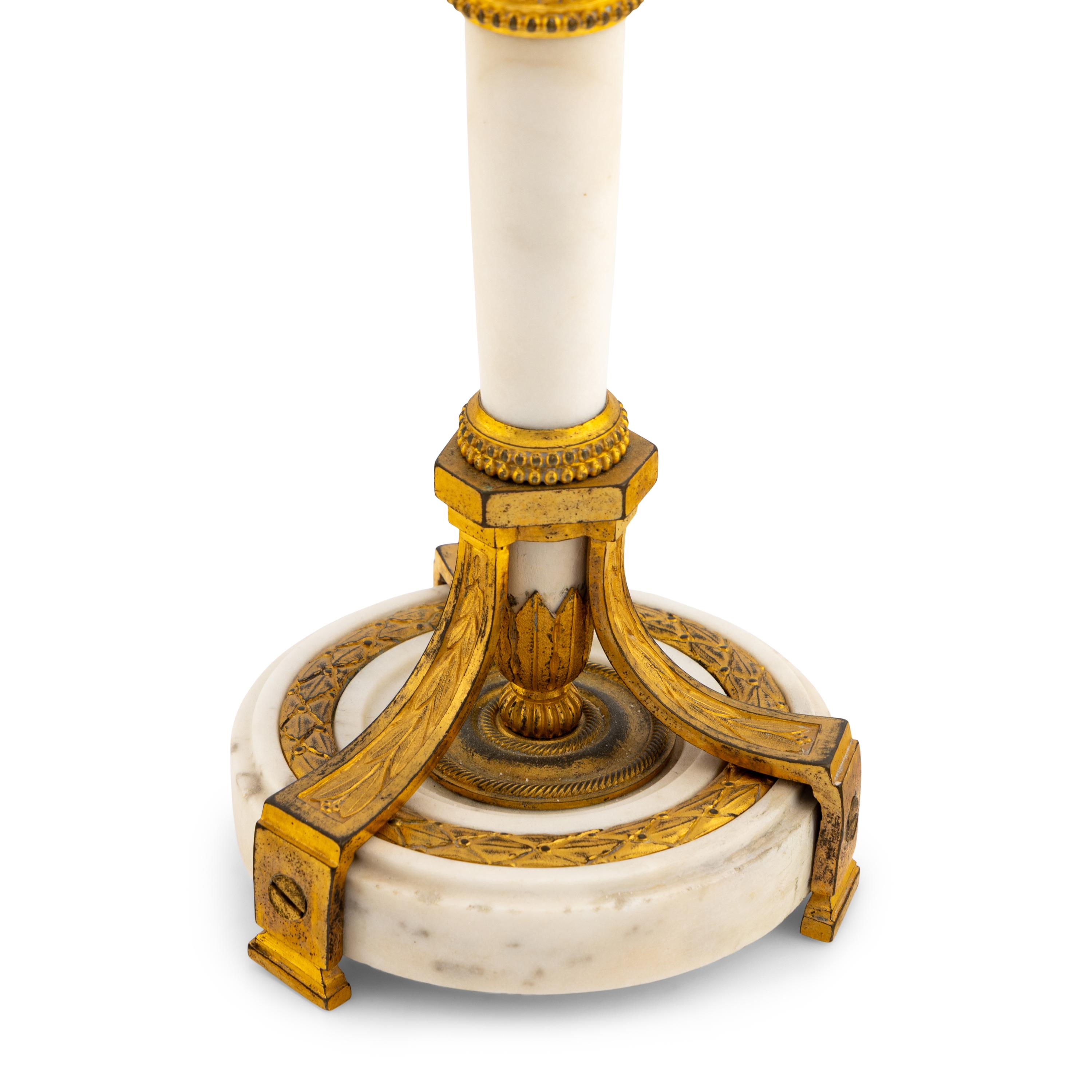 A Pair of Directoire Gilt Bronze and White Marble Candlesticks