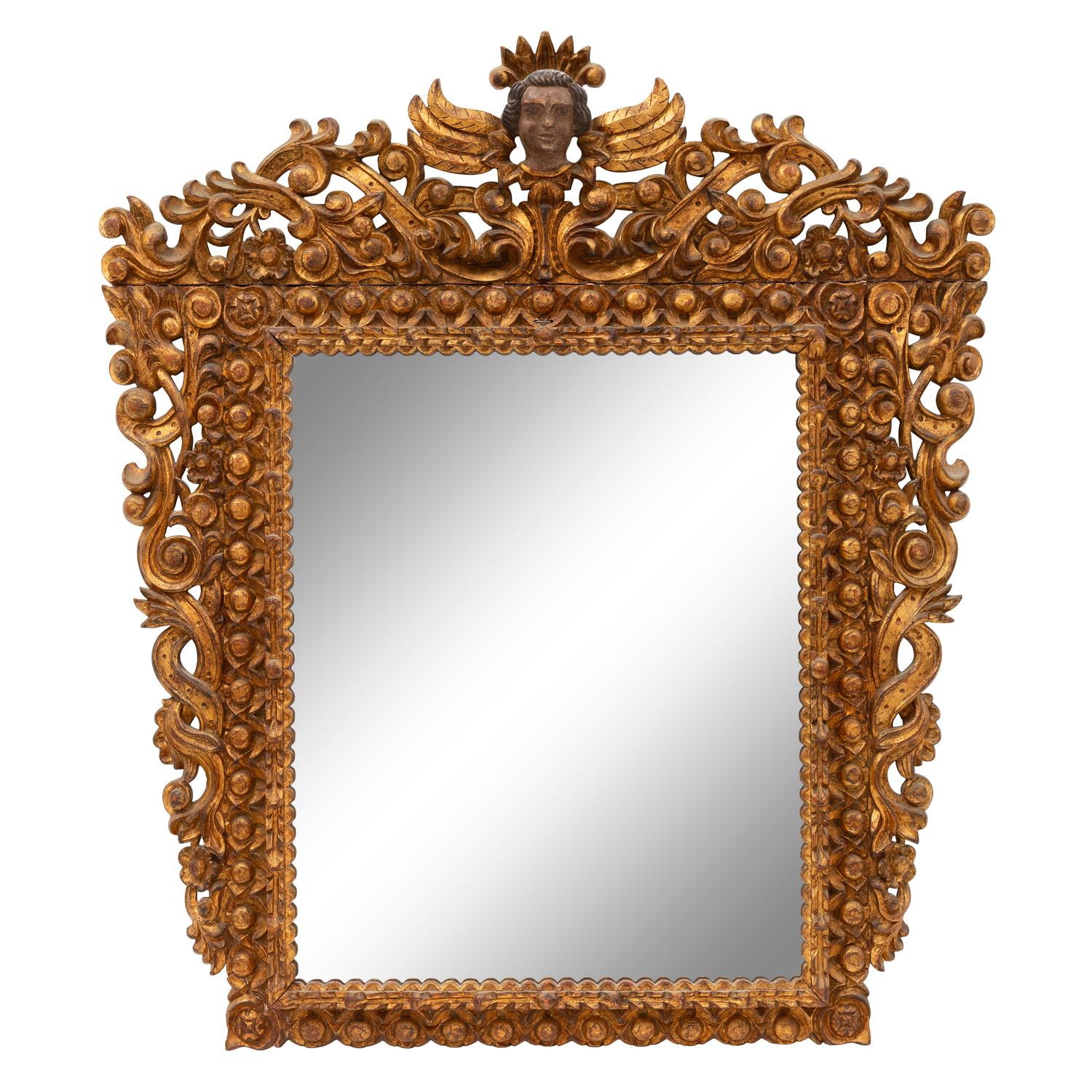 A Spanish Baroque Style Painted and Giltwood Mirror