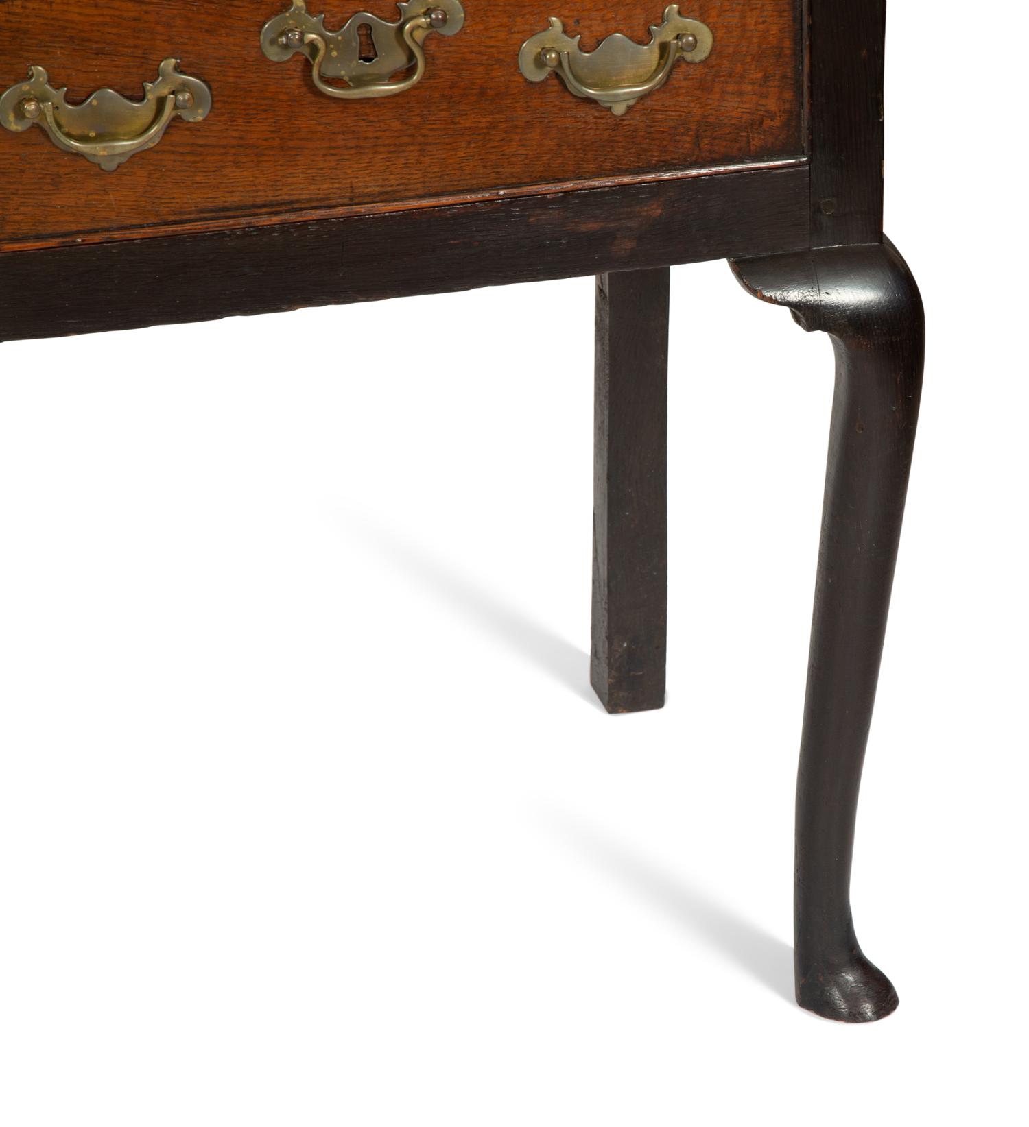 A Queen Anne Oak Three Drawer Sideboard