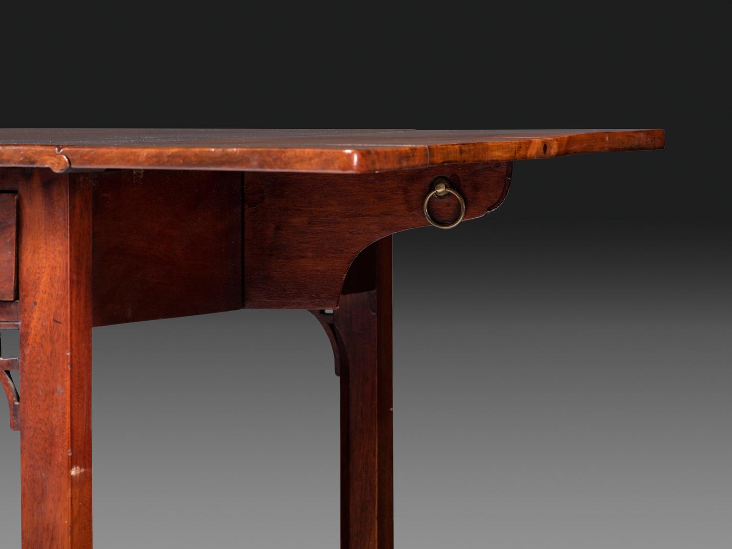 A Late Chippendale Carved and Figured Mahogany Stretcher-Base Pembroke Table