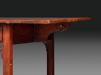 A Late Chippendale Carved and Figured Mahogany Stretcher-Base Pembroke Table