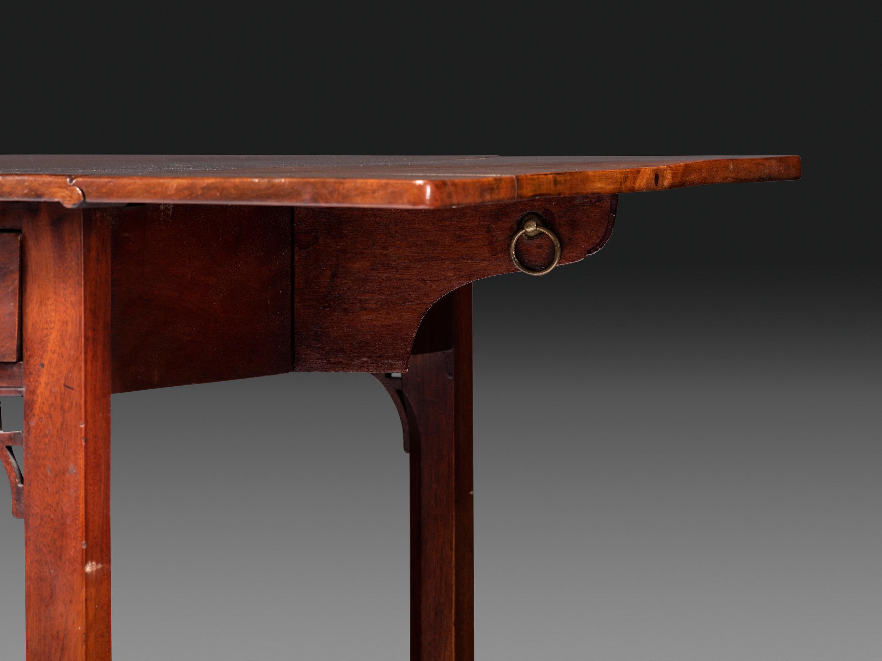 A Late Chippendale Carved and Figured Mahogany Stretcher-Base Pembroke Table