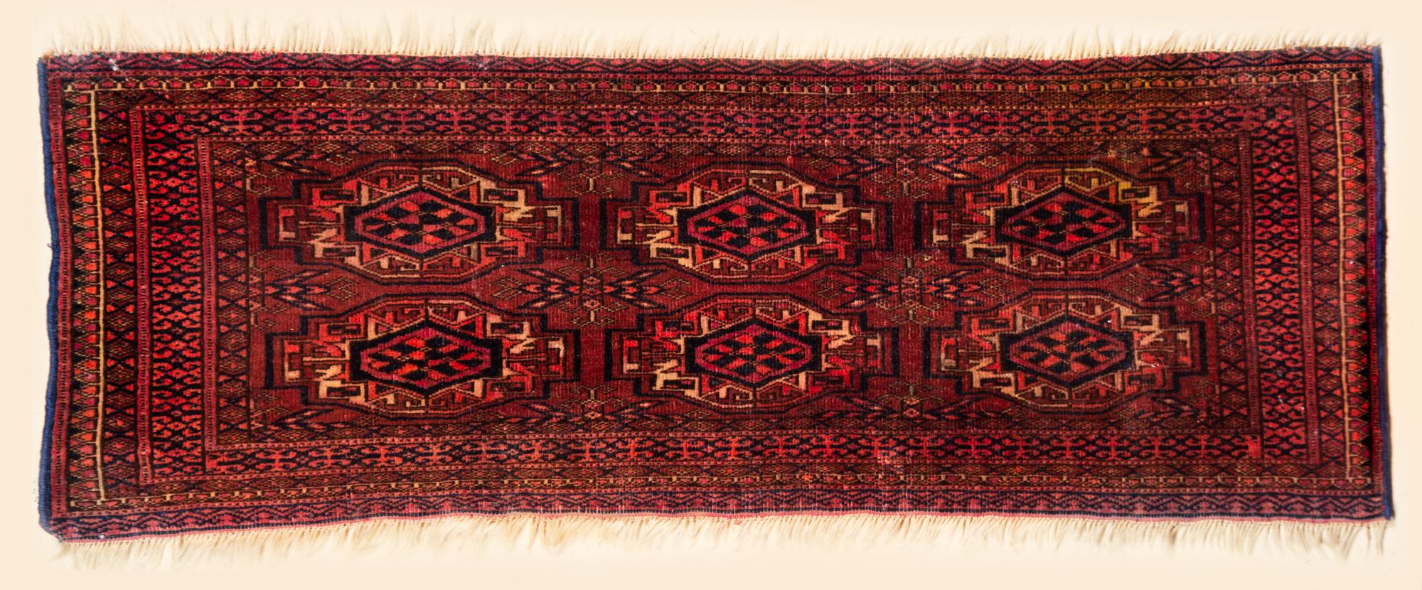 A Bokhara Wool Rug 3 feet 2 inches x 1 foot 1 1/2 inches.