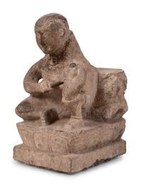 An Asian Carved Stone Seated Figure