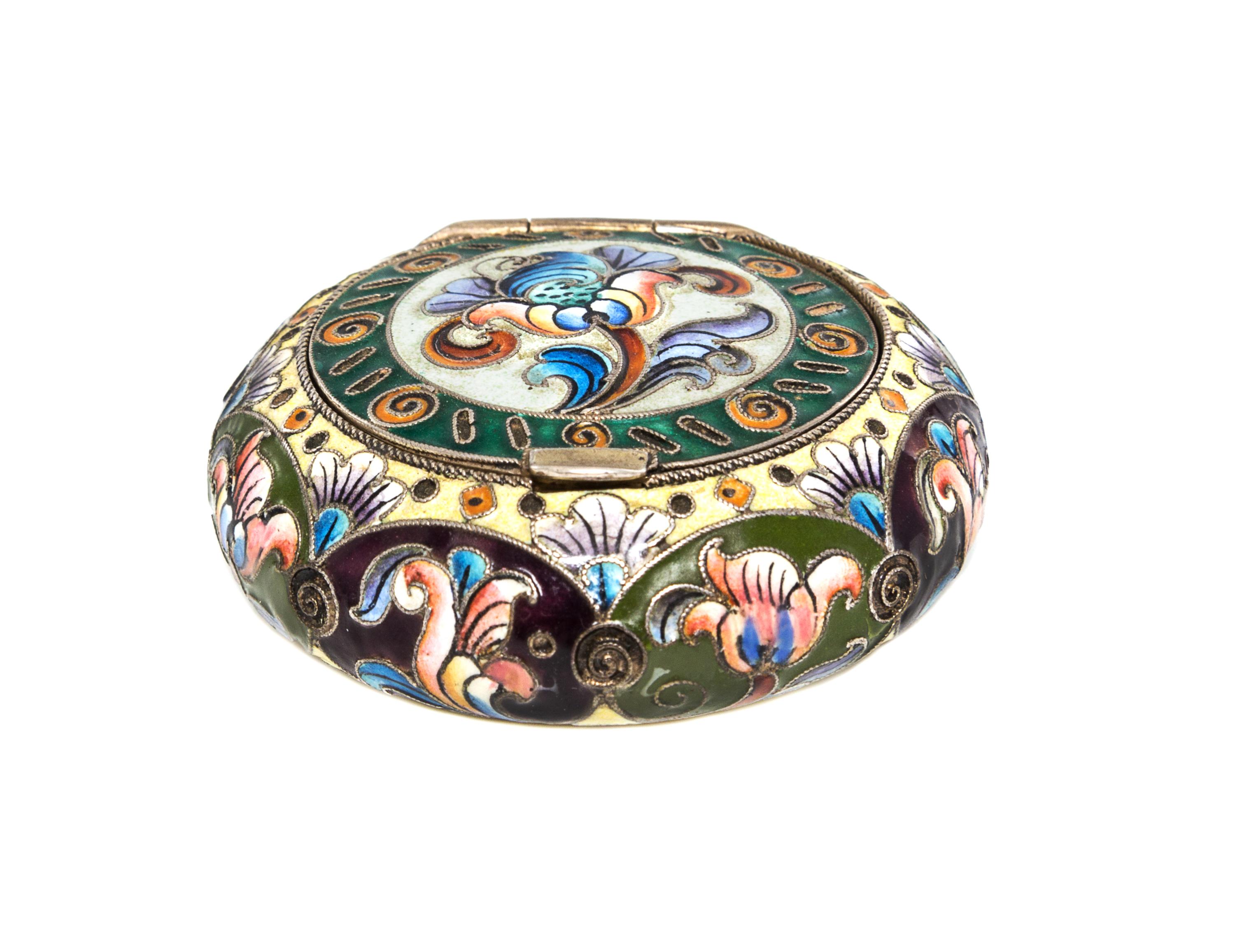 A Russian Enameled Silver Box, 6th Artel, Moscow, 1908-1926, of circular form with polychrome floral decoration.