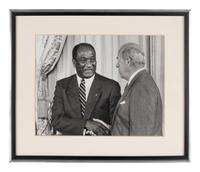 [PERKINS, Edward Joseph (1928-2020)]. A group of 10 photographs in 9 frames, from political figures to Perkins, many signed or inscribed (several presumably with secretarial or facsimile signatures), including:
