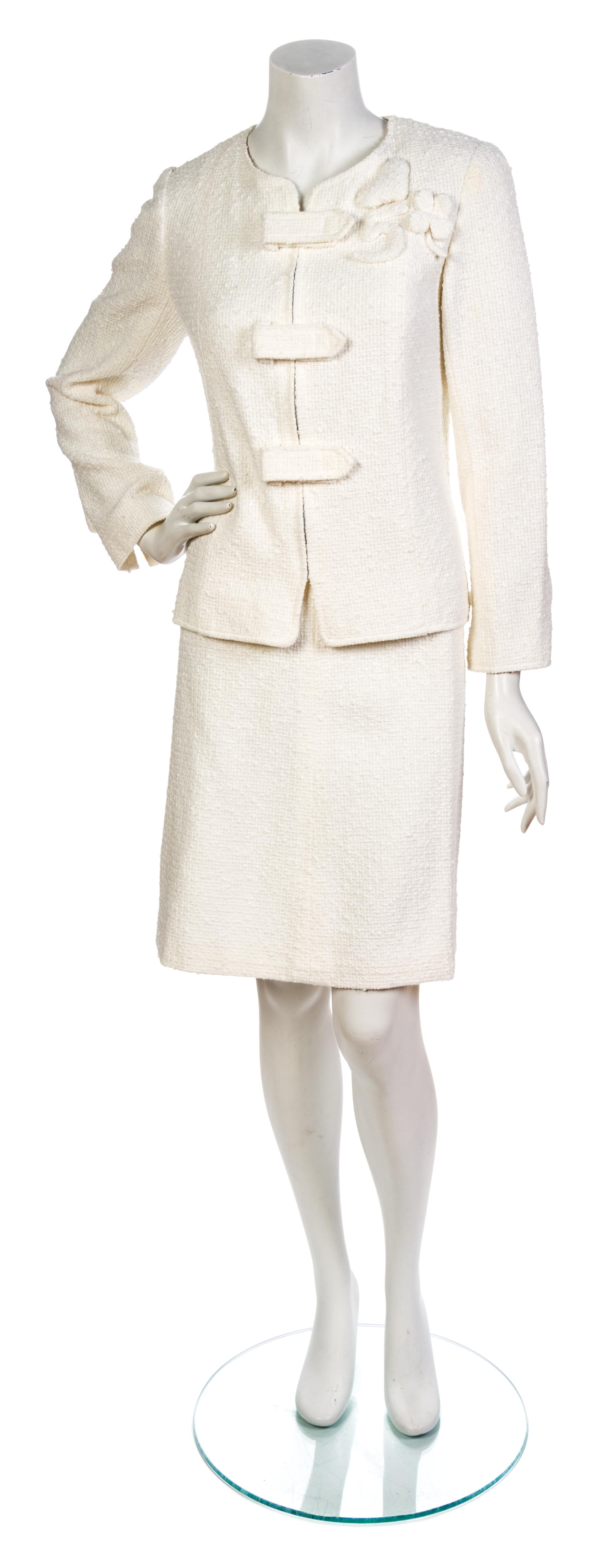 A Chanel White Cotton Boucle Skirt Suit, Jacket size 44, skirt size 42.
