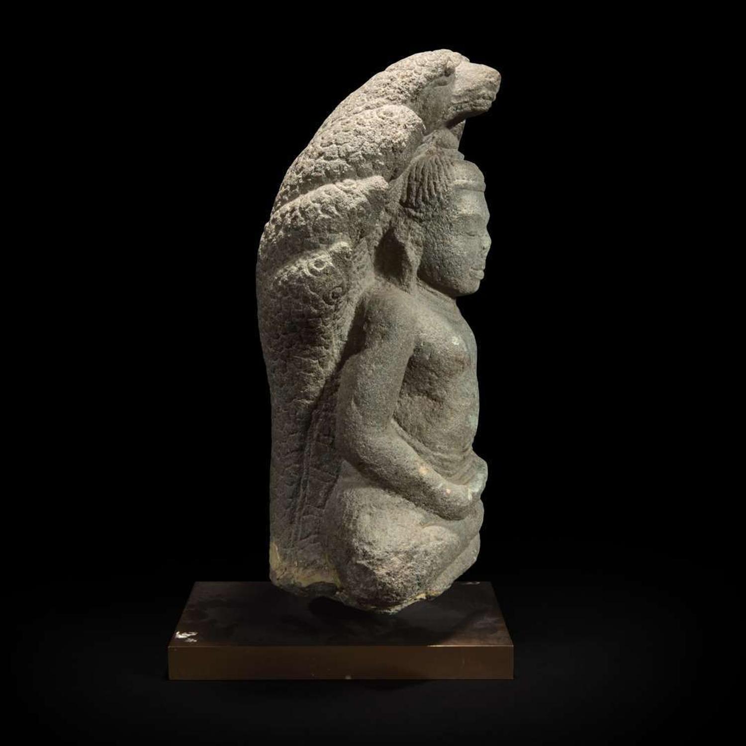 A Khmer style carved stone figure of Buddha seated under a cobra canopy 高棉风格石雕眼镜蛇冠冕佛首