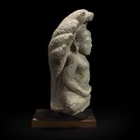A Khmer style carved stone figure of Buddha seated under a cobra canopy 高棉风格石雕眼镜蛇冠冕佛首