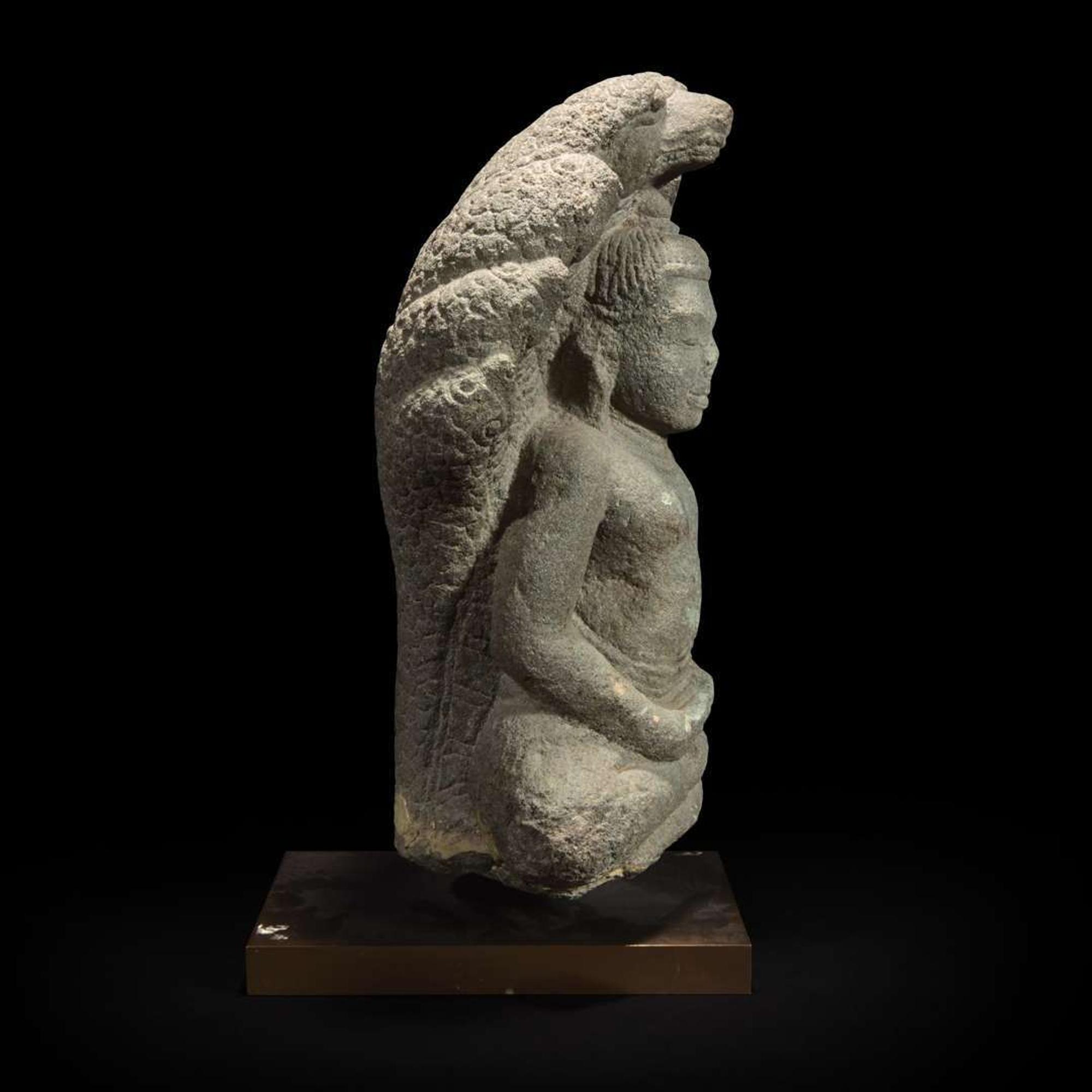 A Khmer style carved stone figure of Buddha seated under a cobra canopy 高棉风格石雕眼镜蛇冠冕佛首