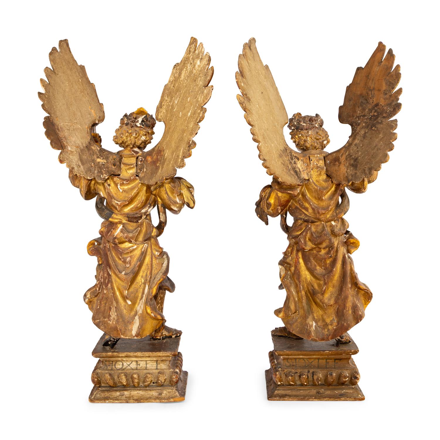A Pair of Italian Painted and Parcel Gilt Figural Altar Prickets