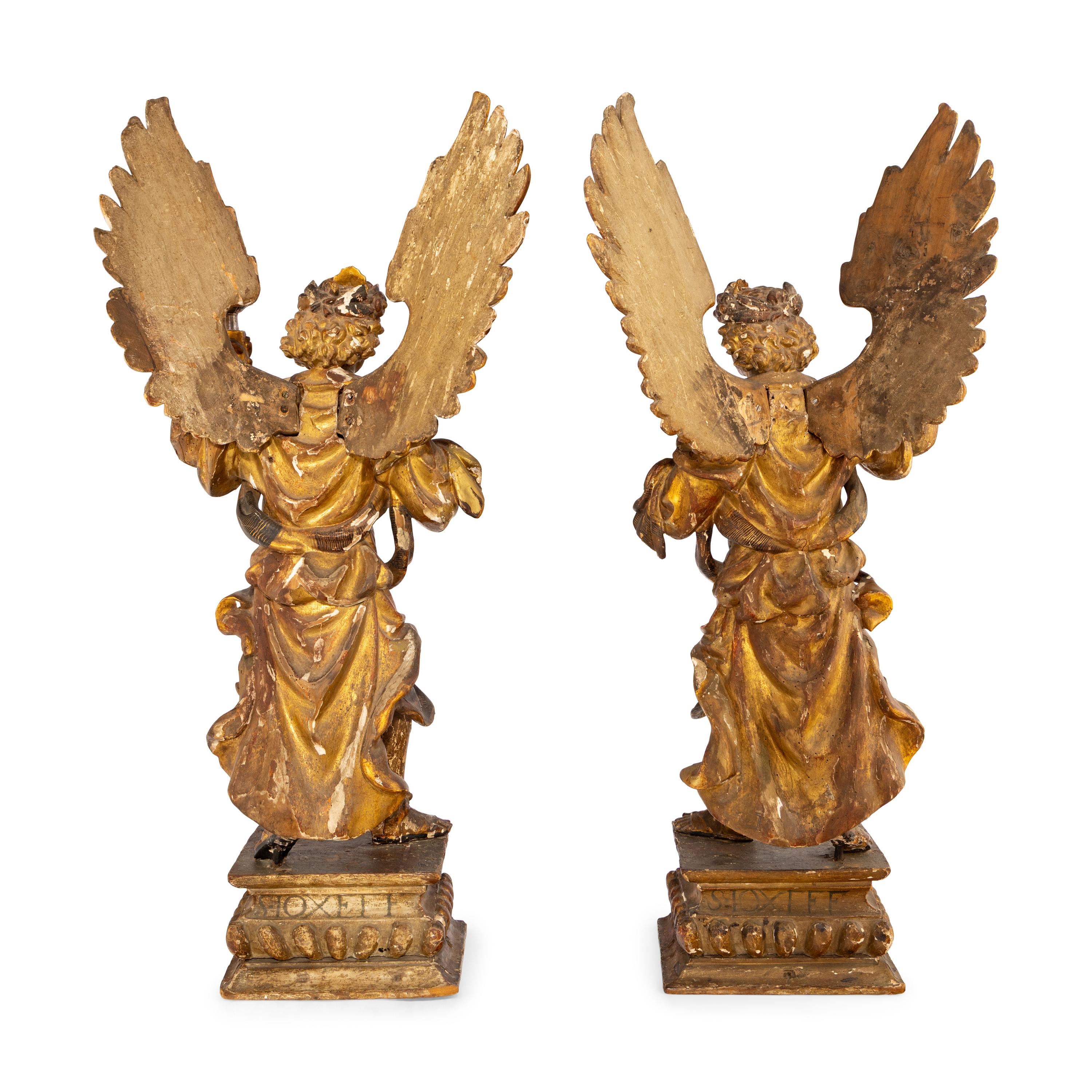 A Pair of Italian Painted and Parcel Gilt Figural Altar Prickets