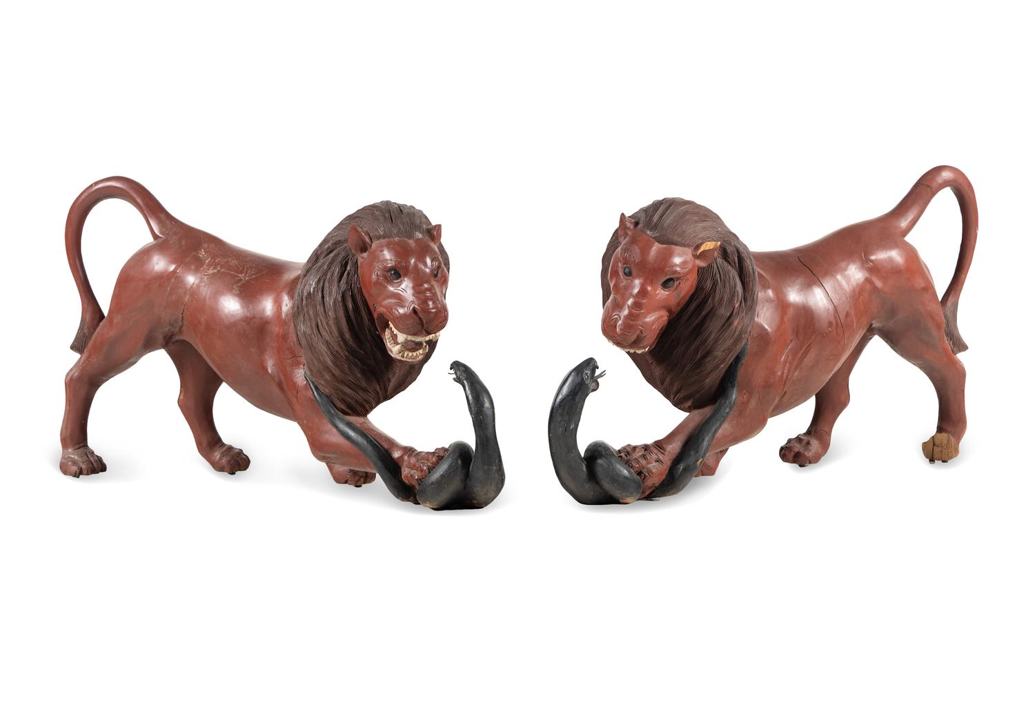 A Pair of Carved and Painted Wood Lions Wrestling Serpents