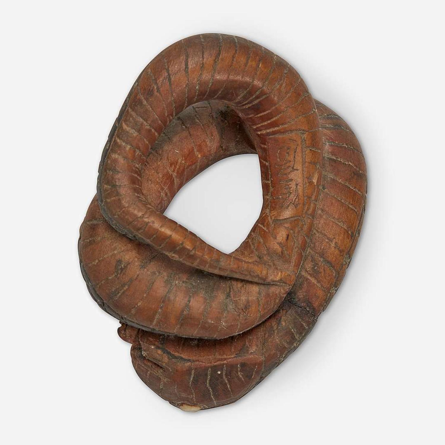 Three Japanese carved wood netsuke: measure and toad, snake and toad, monk and jar