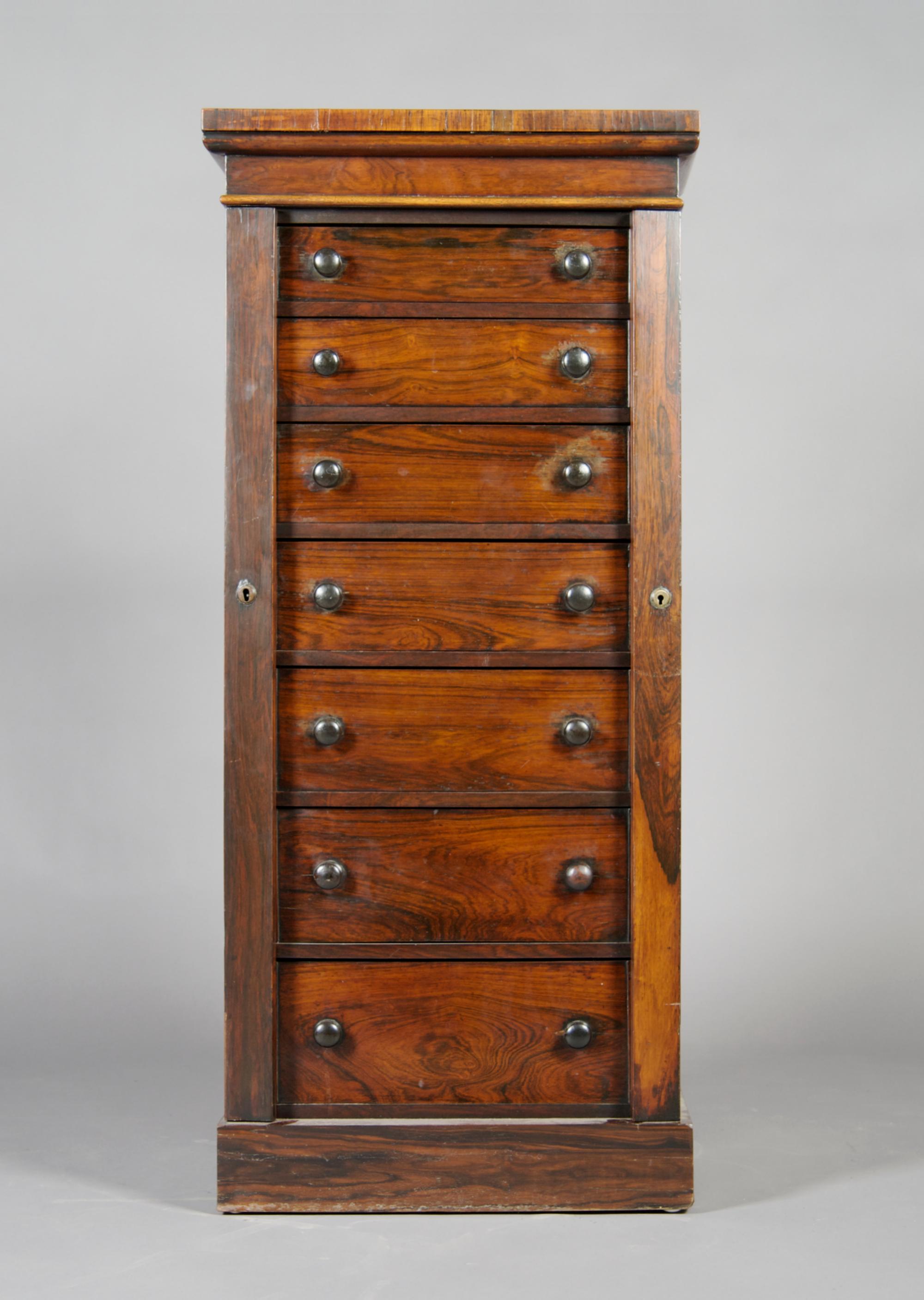 A Rosewood Wellington Chest, Height 47 x width 21 x depth 14 1/4 inches.