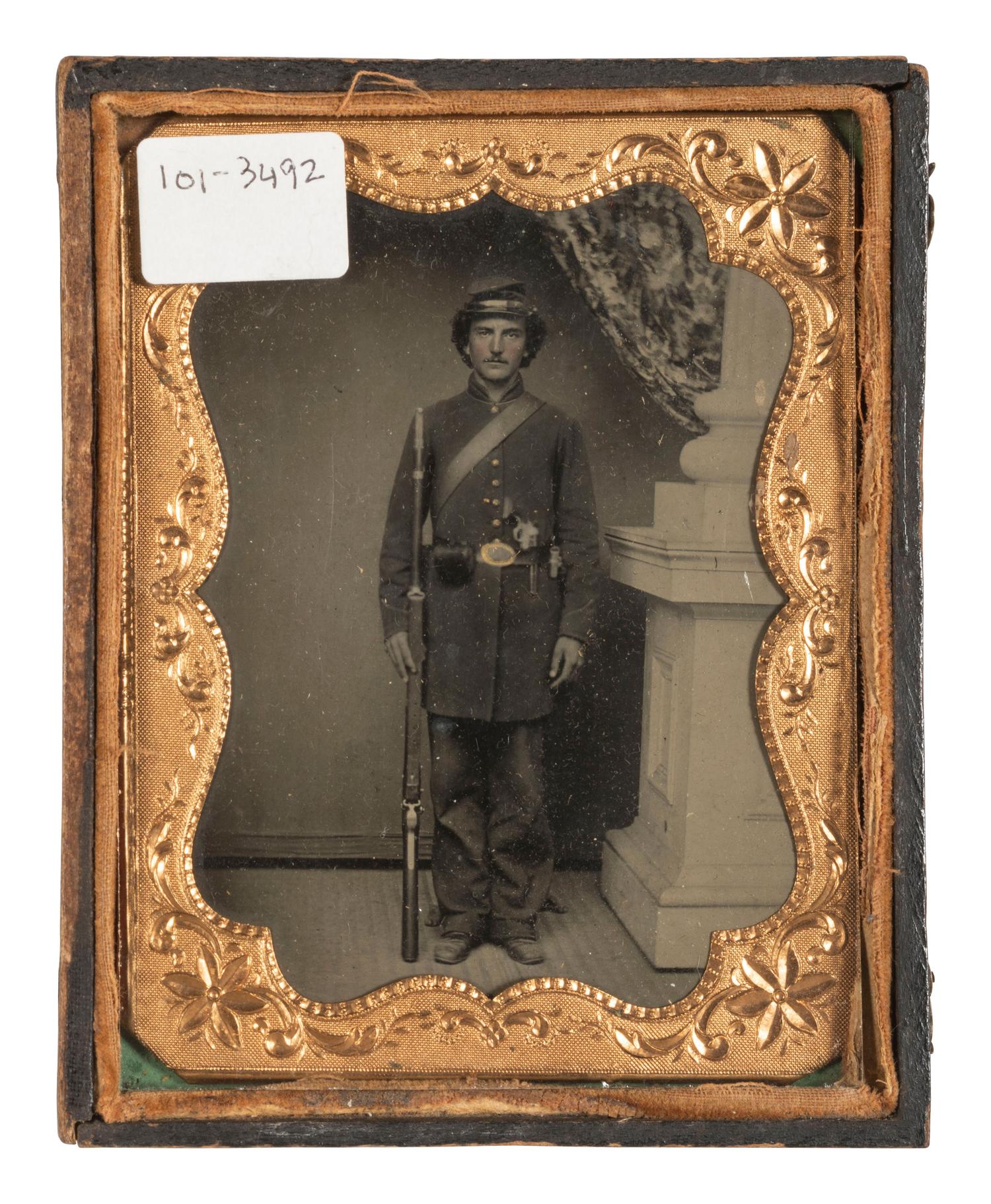 [CIVIL WAR]. Tintype portrait of a doubly armed soldier in full kit.