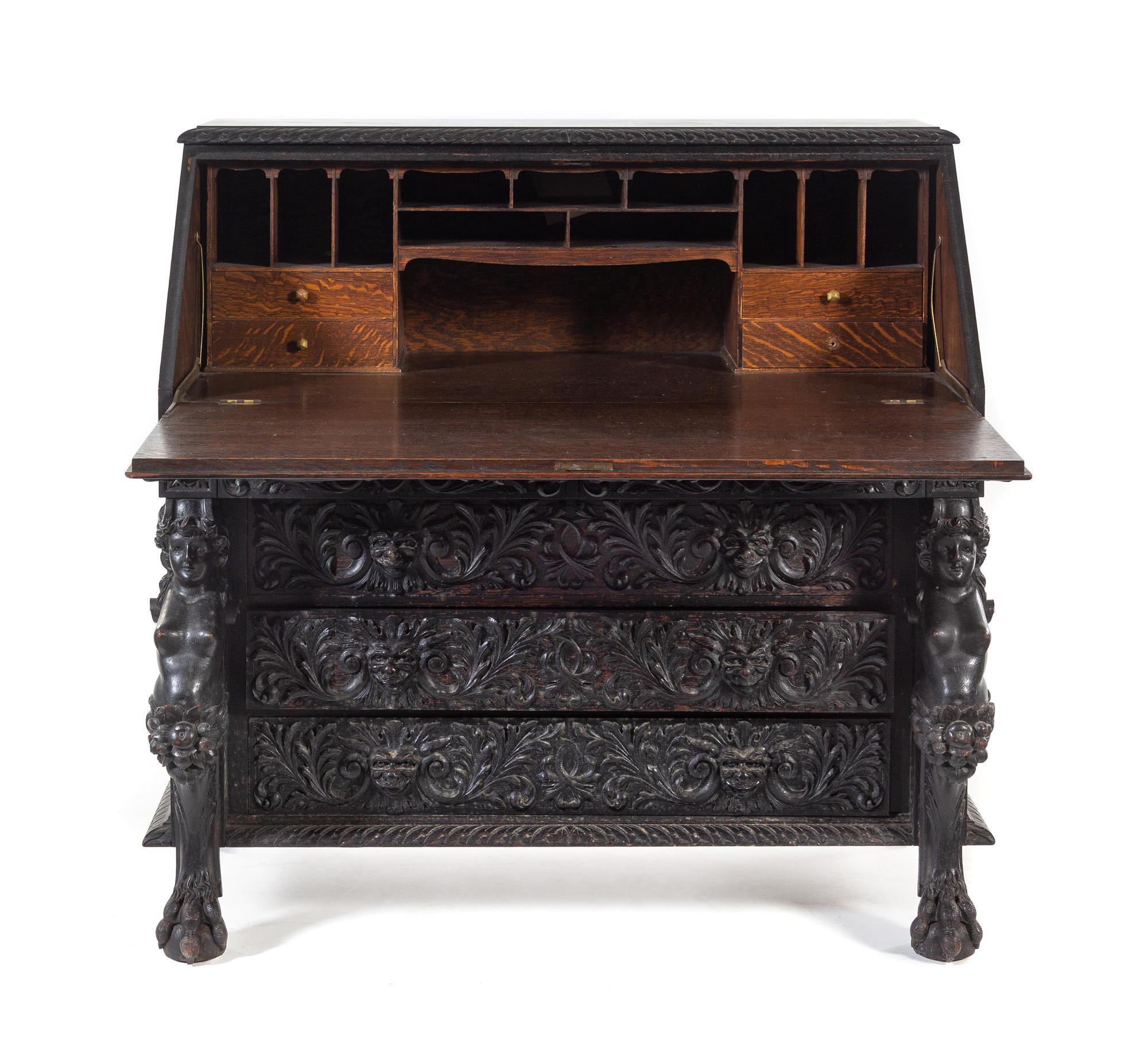 A Renaissance Revival Carved Slant-Front Desk