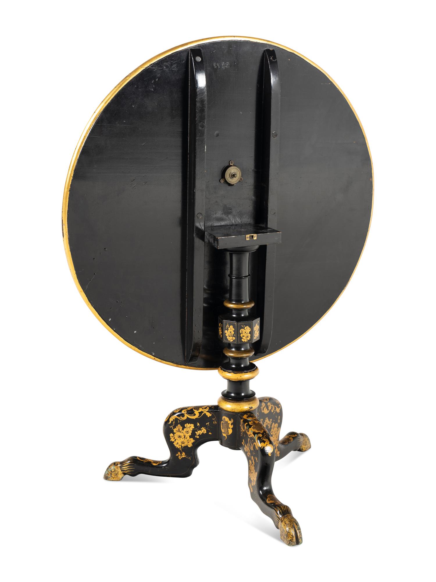 A Regency Style Lacquered and Gilt Decorated Tilt Top Tea Table