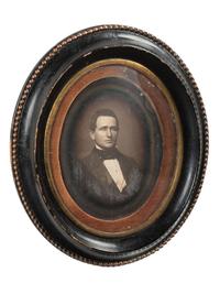 [EARLY PHOTOGRAPHY]. Whole plate daguerreotype of a young man housed in oval wall frame.
