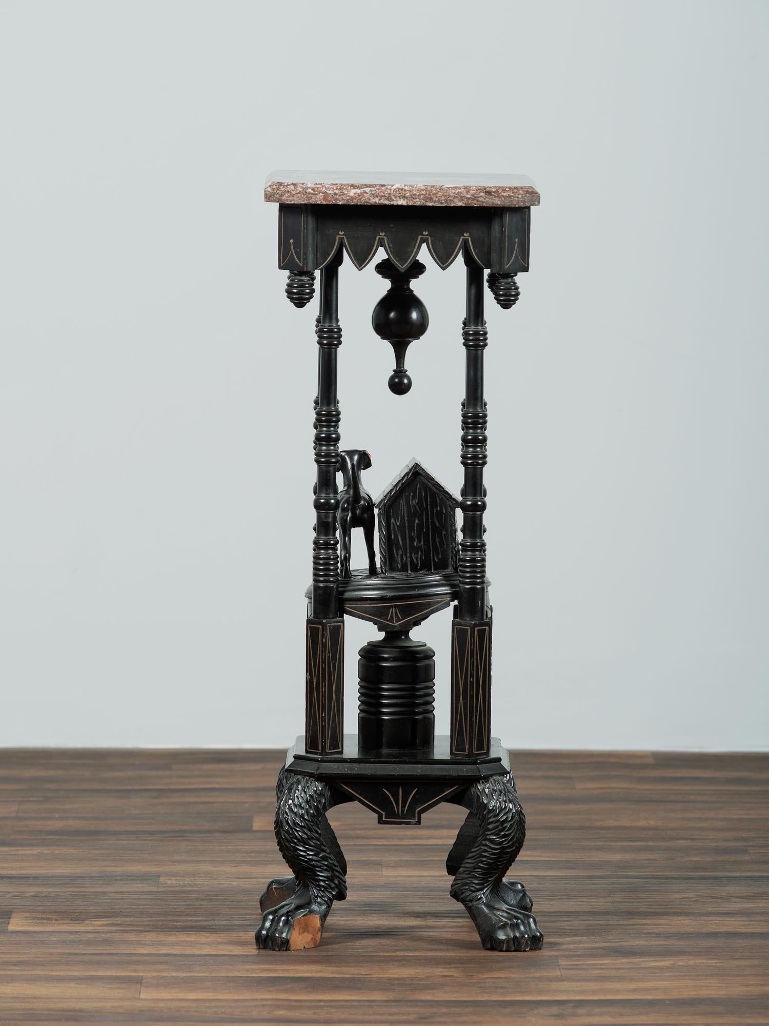 A Victorian Marble-Top Carved and Ebonized Parlor Table with Dog