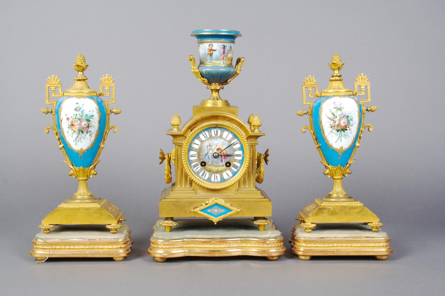 A French Gilt Bronze and Sevres Style Porcelain Clock Garniture, Height of clock 14 inches.