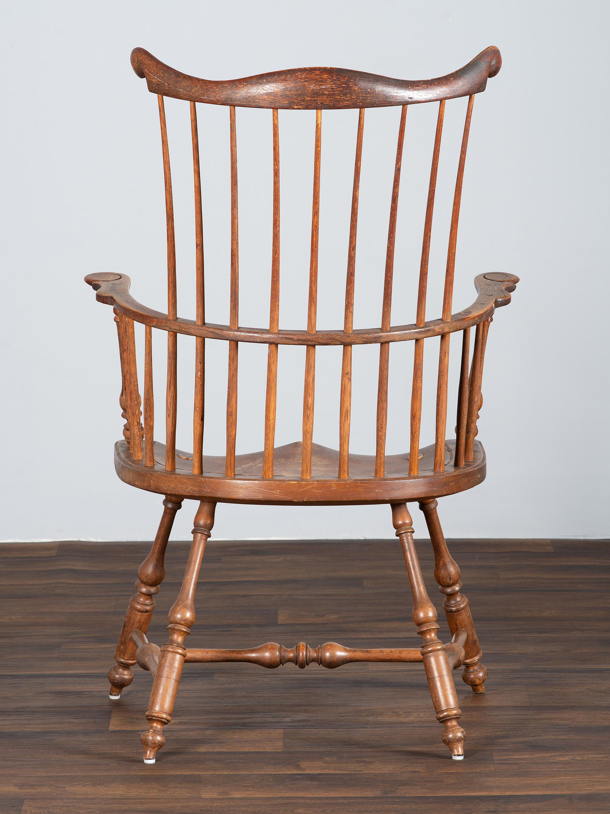A Volute and Scroll Carved and Reel Turned Windsor Armchair
