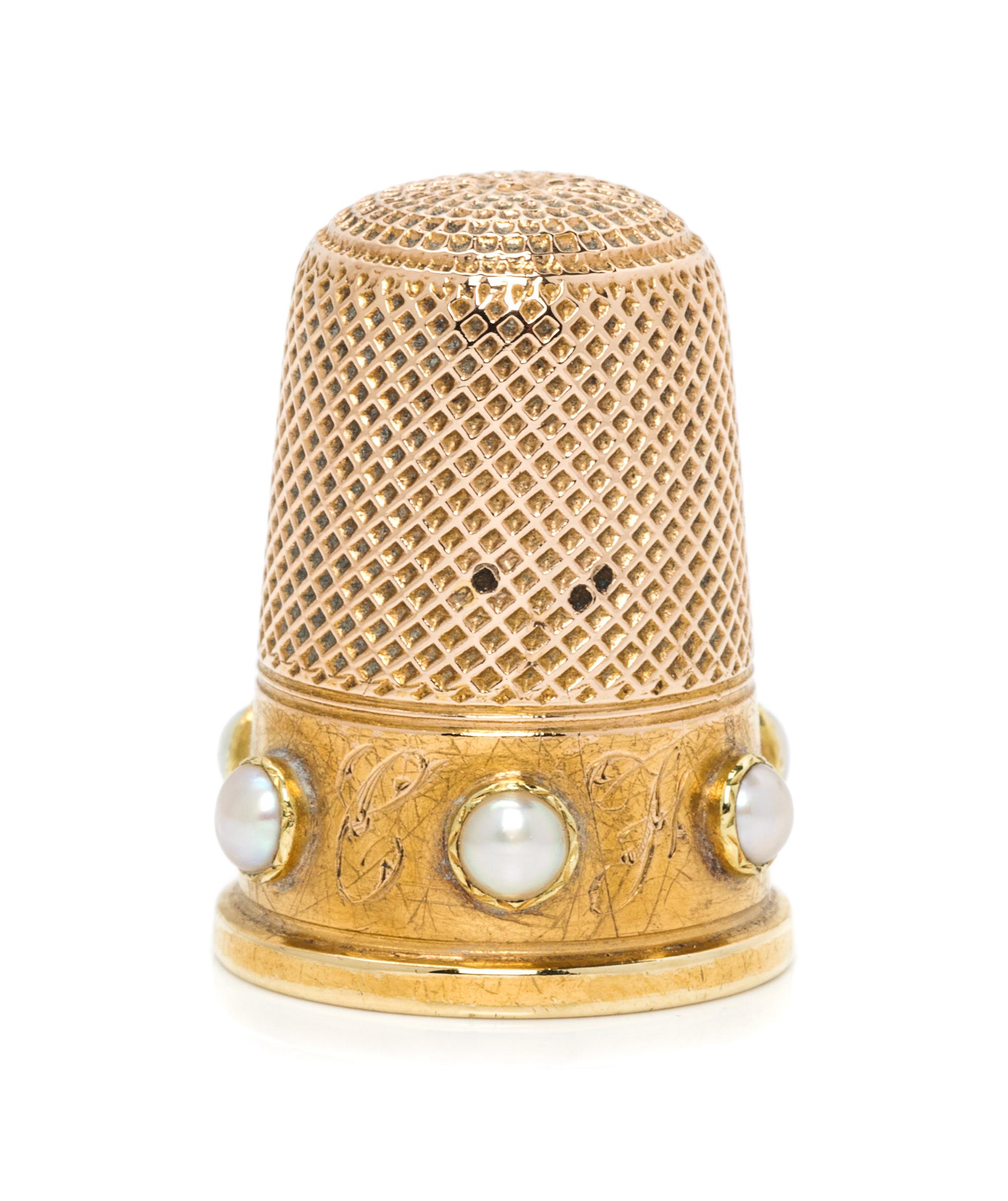 A Yellow Gold and Pearl Inset Thimble, , the knurled top and diapered body above a plain band with engraved initials spaced with inset