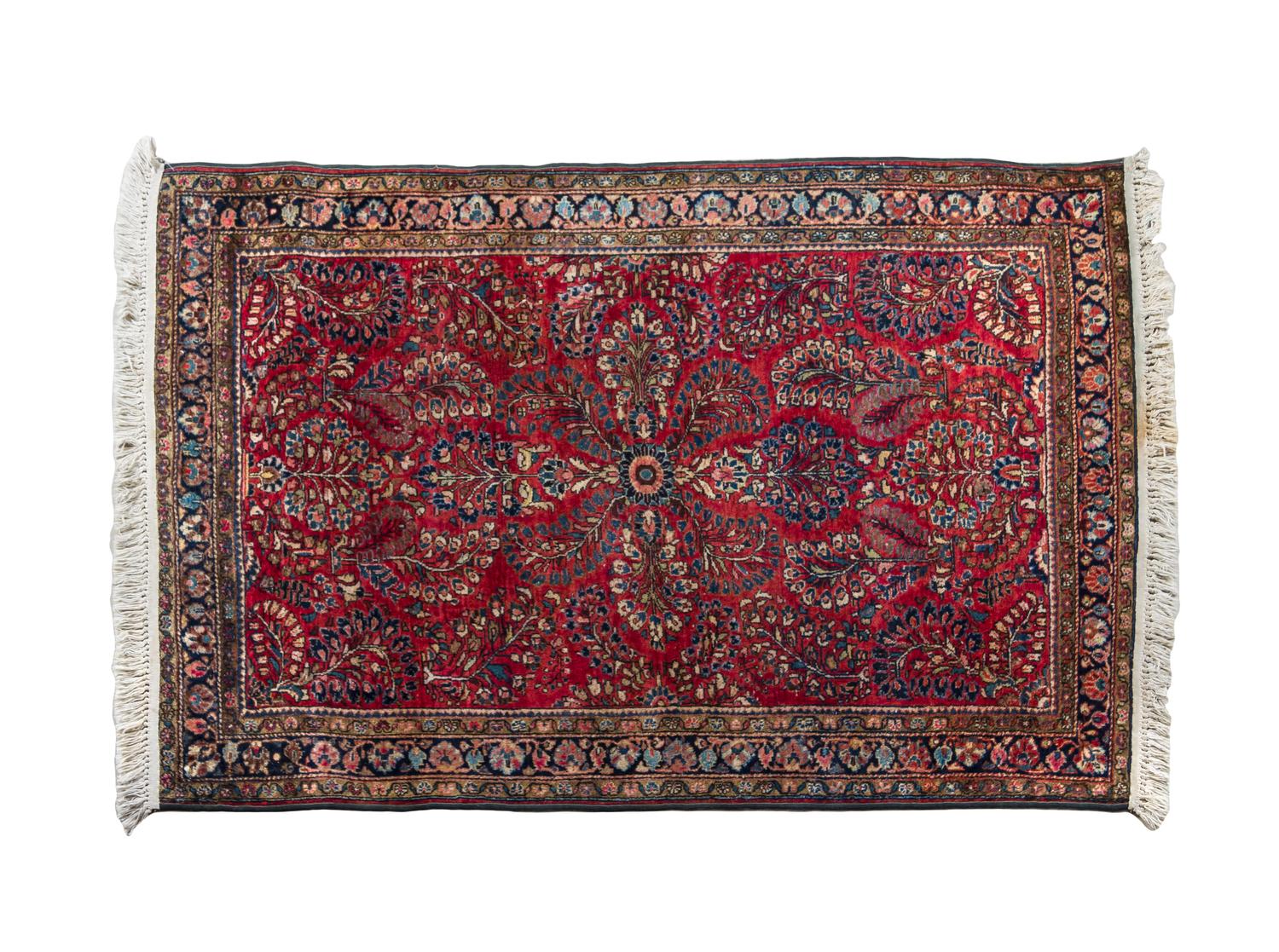 A Sarouk Wool Rug 4 feet 11 inches x 3 feet 9 inches.