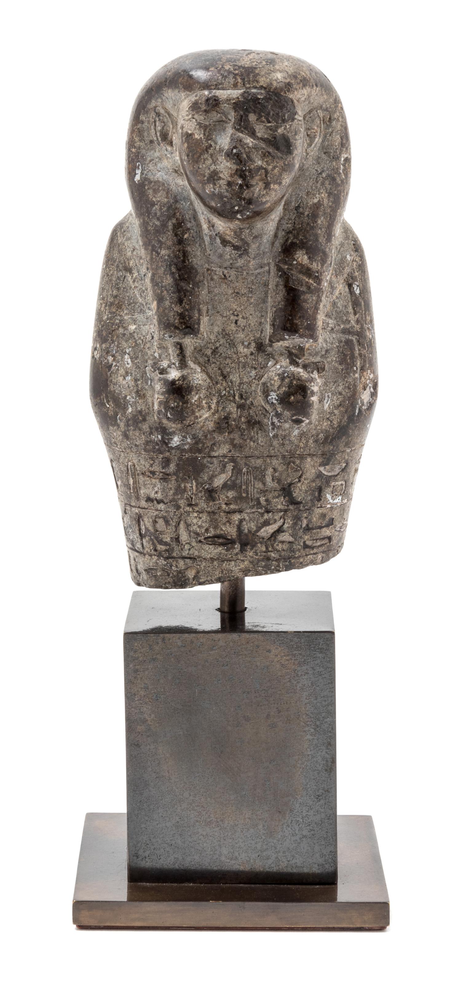 An Egyptian Stone Ushabti of Wedjarenes — 25TH/26TH DYNASTY, CIRCA 680-620 B.C.E.