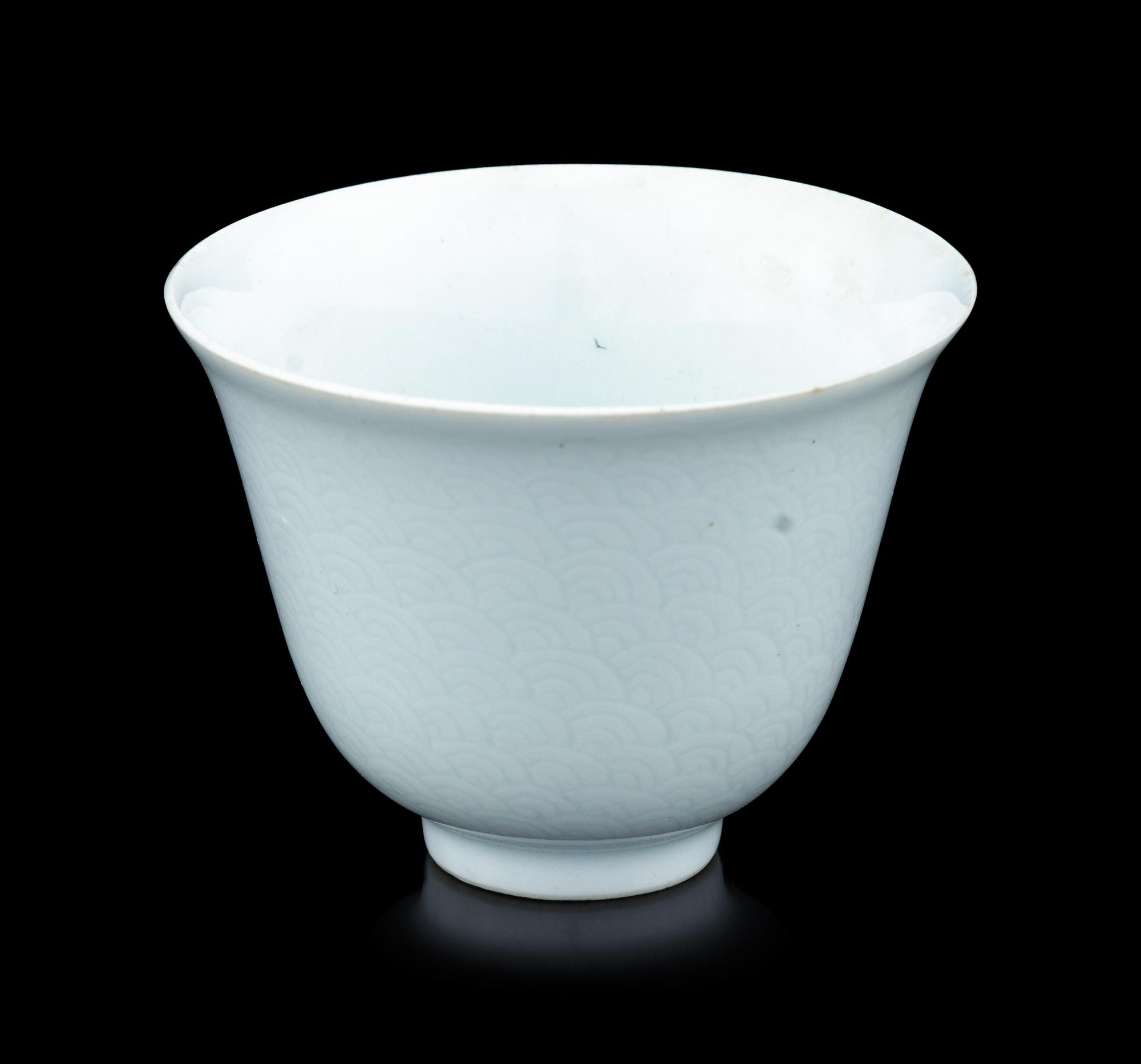 A Chinese Incised White Glazed Porcelain 'Waves' Cup