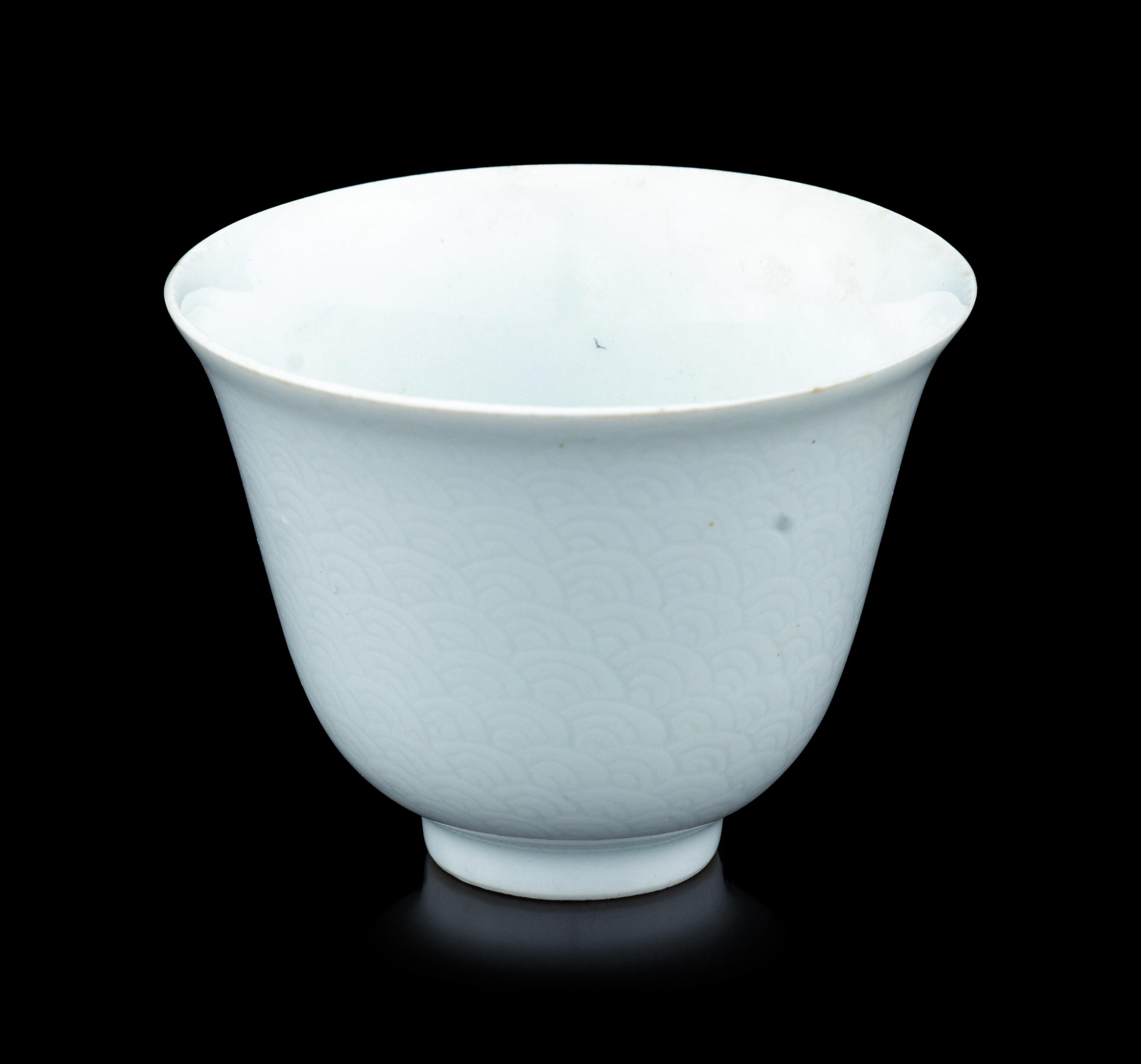 A Chinese Incised White Glazed Porcelain 'Waves' Cup
