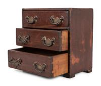 A Stained Pine Miniature Chest of Drawers