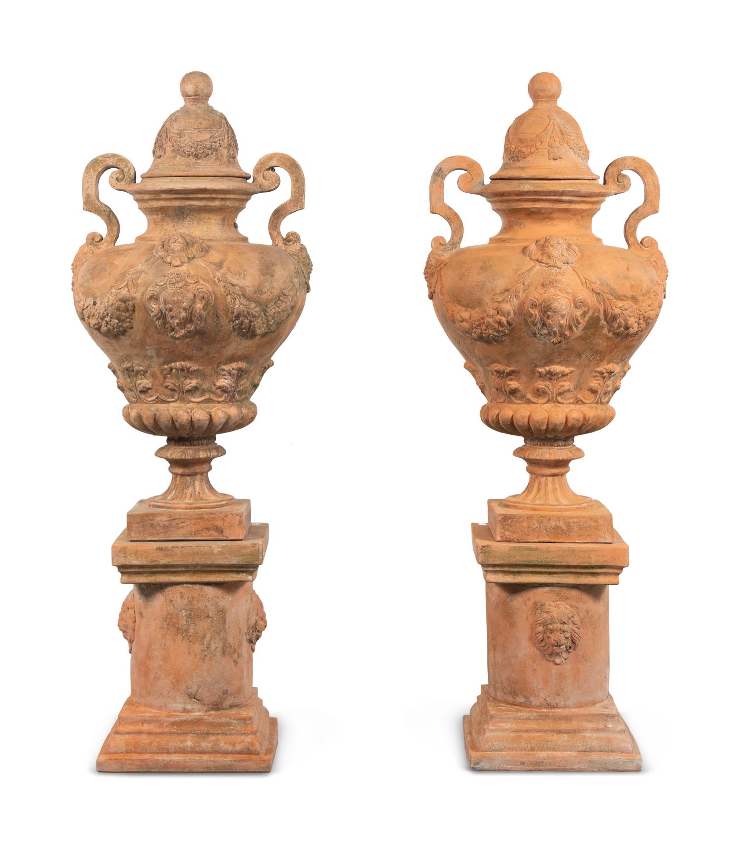 A Large Pair of Neoclassical Terra Cotta Covered Urns on Stands