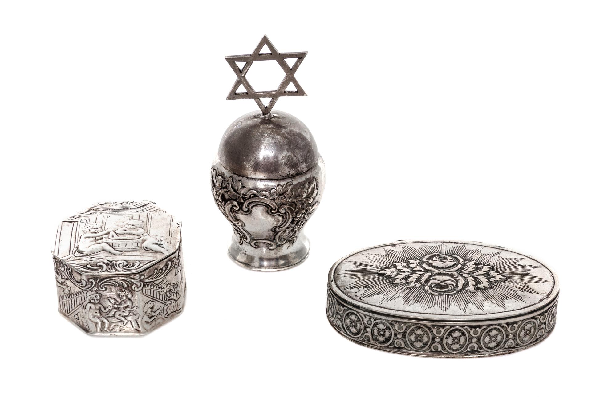Three German Silver Boxes, 19th/20th Century, comprising an oval box with floral decoration, an octagonal box with figural decoration a