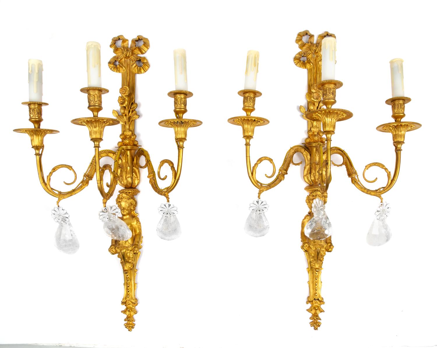 A Pair of Louis XV Style Bronze and Rock Crystal Three-Light Figural Sconces Height 27 1/2 inches. — 20TH CENTURY