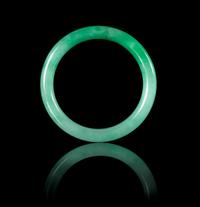 An Apple Green and Celadon Jadeite Bangle 69.08 x 7.9 mm.