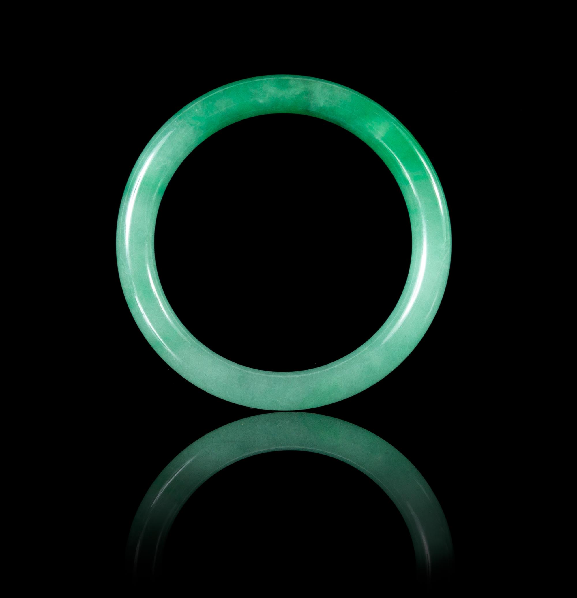 An Apple Green and Celadon Jadeite Bangle 69.08 x 7.9 mm.