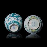 A Chinese Doucai Decorated Dish and a "Dragon" Jar and Cover 斗彩壽桃紋盤及綠釉龍紋蓋罐各一