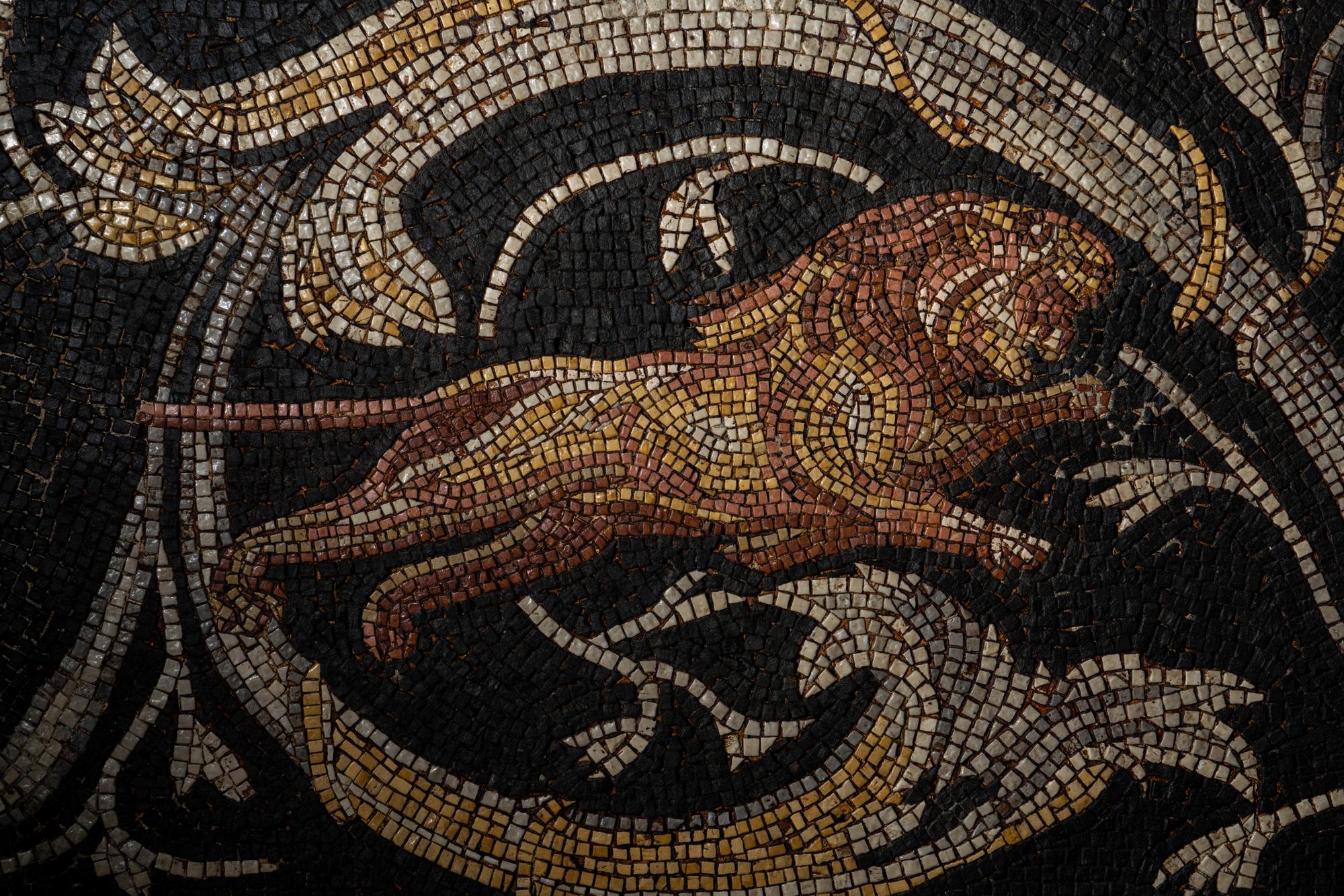 A Roman-Style Polychrome Mosaic Panel with a Bearded Head and Two Animals