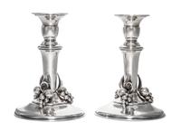 A Pair of Canadian Silver Candlesticks, Carl Poul Petersen, Montreal, 20th Century, each of baluster form with applied decoration.