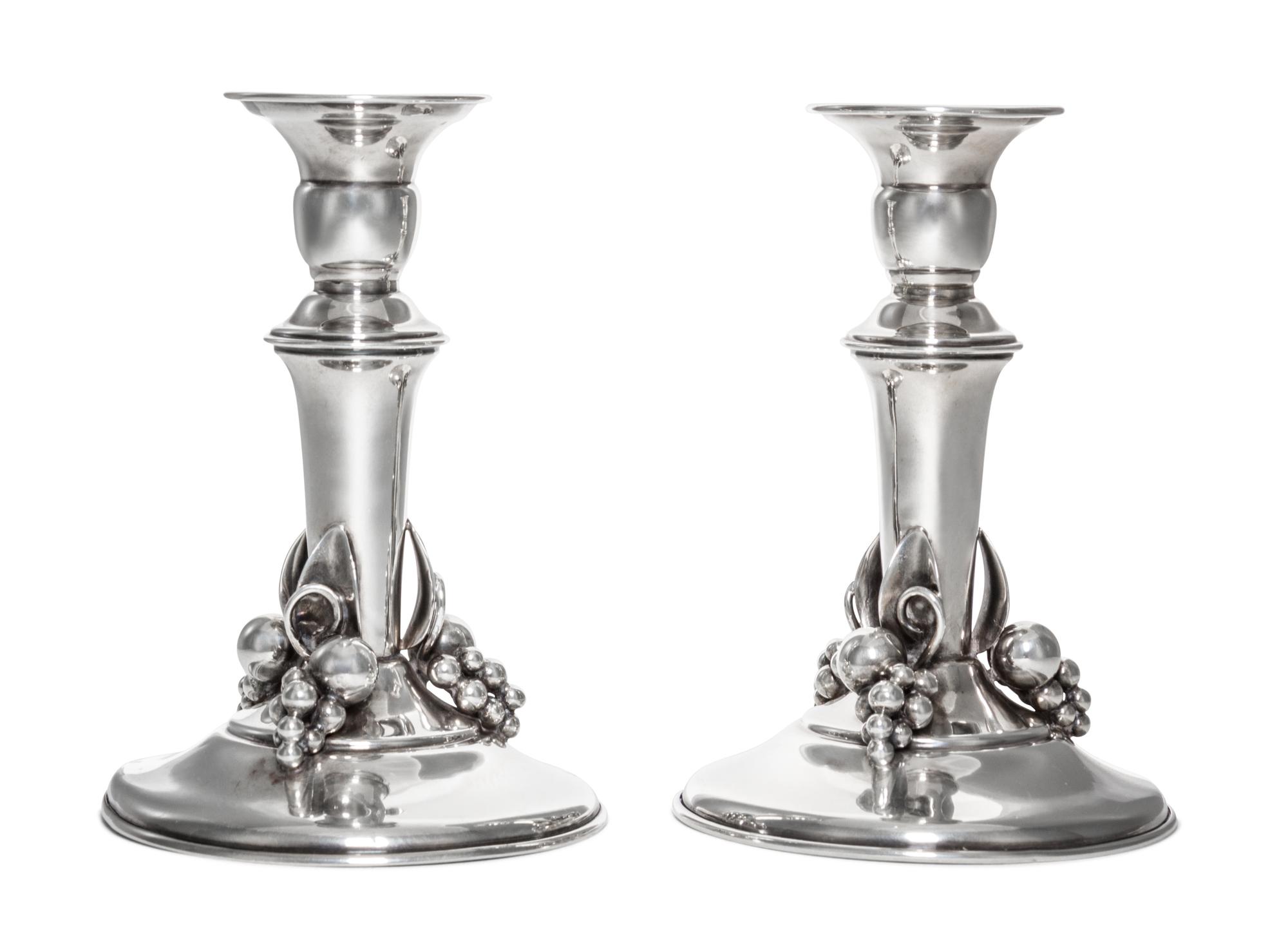 A Pair of Canadian Silver Candlesticks, Carl Poul Petersen, Montreal, 20th Century, each of baluster form with applied decoration.