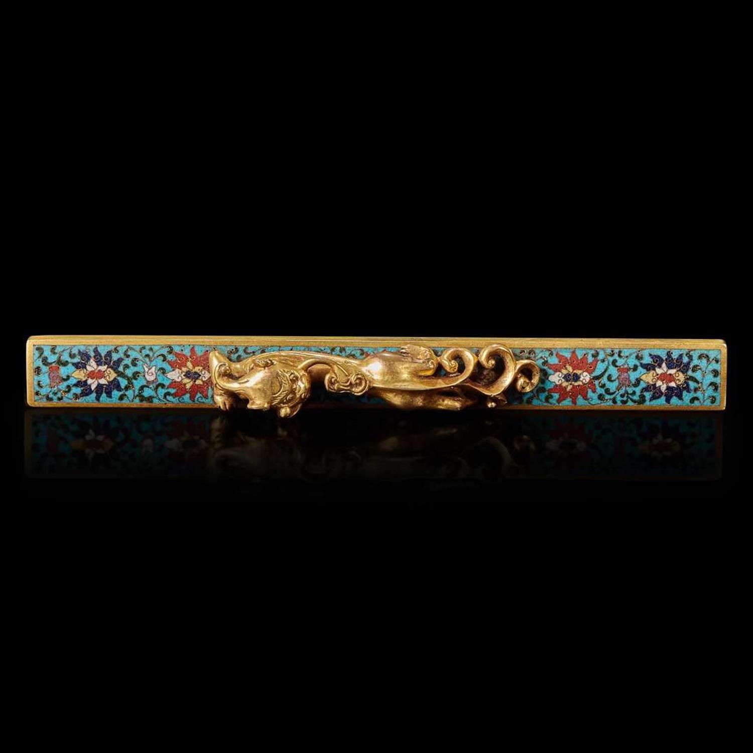 A Chinese gilt-bronze and cloisonné "Qilong" scroll weight